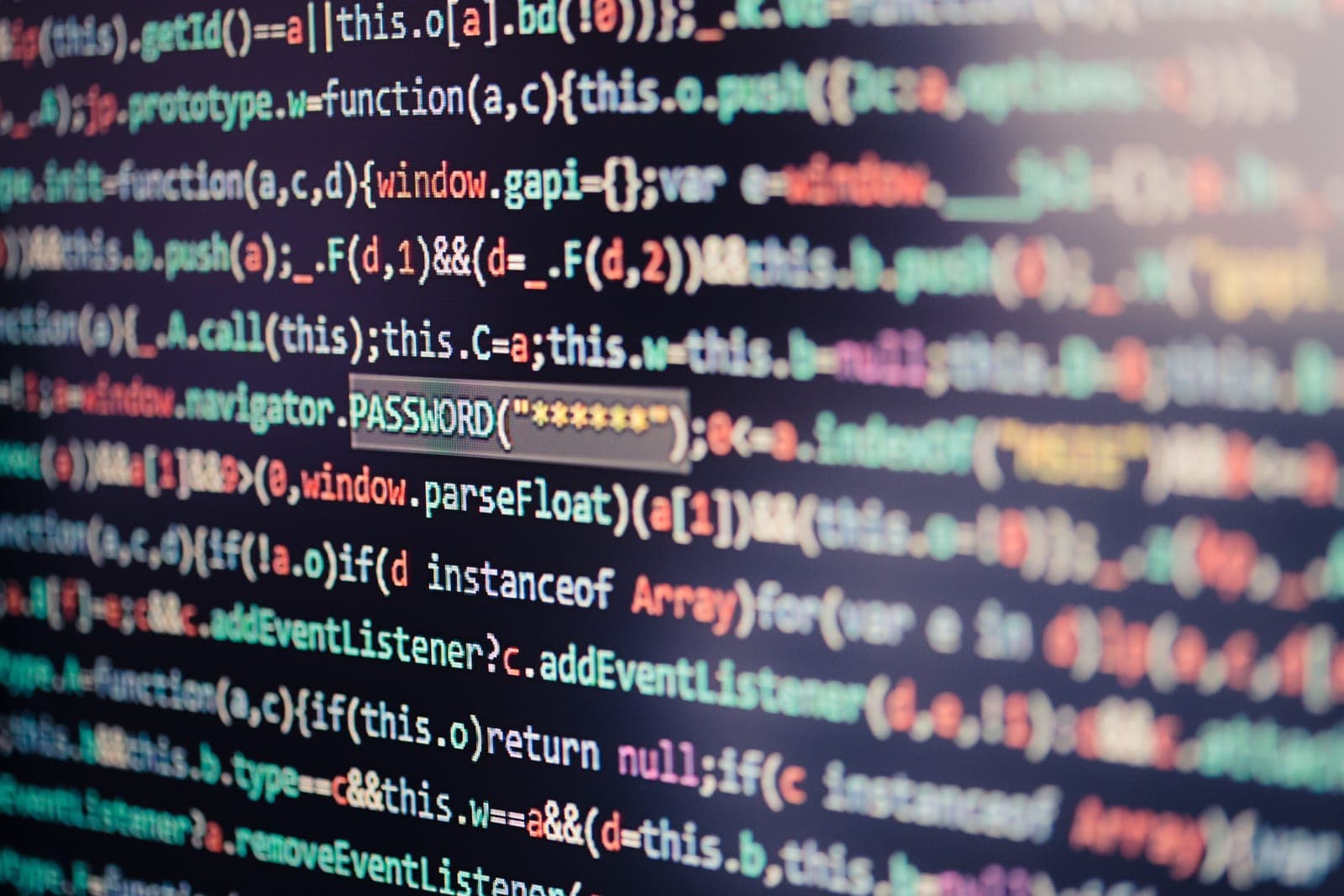 Developer reviewing code on a large monitor while running security patches